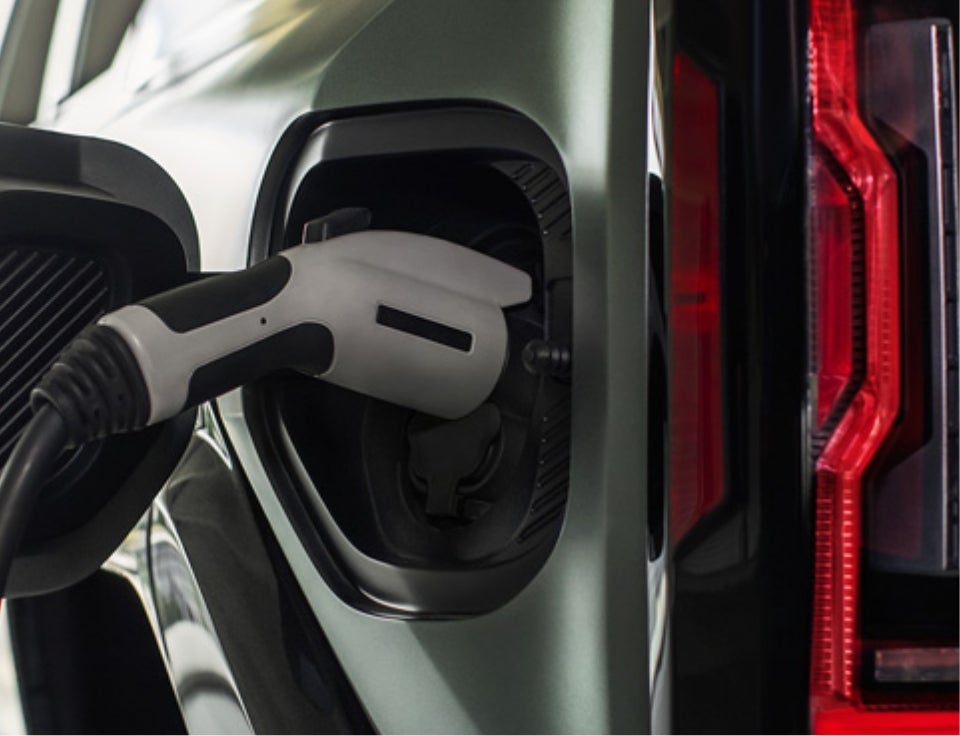 Close up of charging port with charger plugged in on a GMC Hummer EV SUV - Eaton GMC in Houston MS